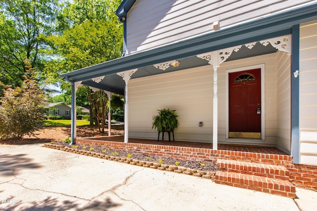 view of exterior entry with a porch