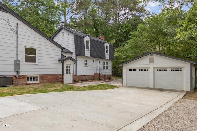 4713 Erwin Rd, Durham, NC 27705 - view of home's exterior featuring an outdoor structure, central AC unit, a chimney, a detached garage, and a shingled roof