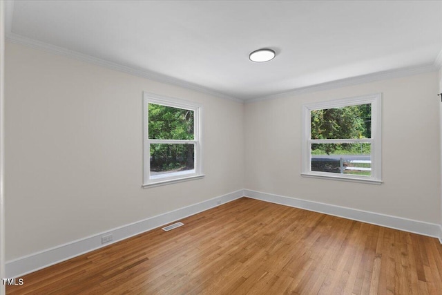 4713 Erwin Rd, Durham, NC 27705 - unfurnished room featuring plenty of natural light, light wood-style flooring, crown molding, and baseboards