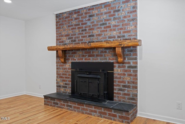 4713 Erwin Rd, Durham, NC 27705 - detailed view of baseboards, wood finished floors, and a brick fireplace