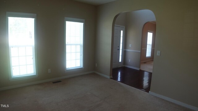 919 Middle Ground Ave, Rolesville, NC 27571 - carpeted spare room featuring arched walkways, healthy amount of natural light, and baseboards