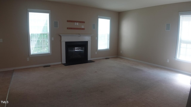 919 Middle Ground Ave, Rolesville, NC 27571 - unfurnished living room with a fireplace with flush hearth, baseboards, and light carpet