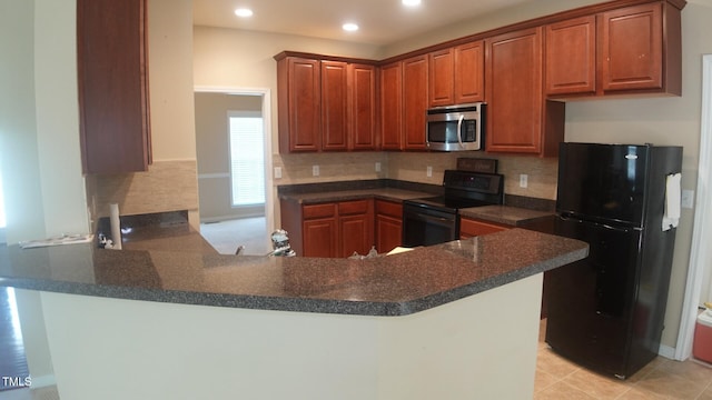 919 Middle Ground Ave, Rolesville, NC 27571 - kitchen with appliances with stainless steel finishes, decorative backsplash, dark countertops, a peninsula, and recessed lighting