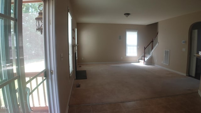919 Middle Ground Ave, Rolesville, NC 27571 - spare room featuring dark colored carpet, arched walkways, stairs, and baseboards