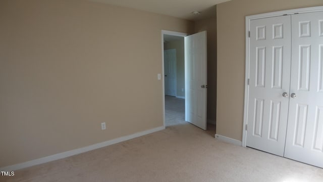 919 Middle Ground Ave, Rolesville, NC 27571 - unfurnished bedroom with light carpet, a closet, and baseboards