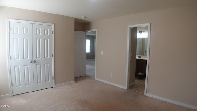 919 Middle Ground Ave, Rolesville, NC 27571 - unfurnished bedroom featuring carpet, a closet, baseboards, ensuite bathroom, and a sink