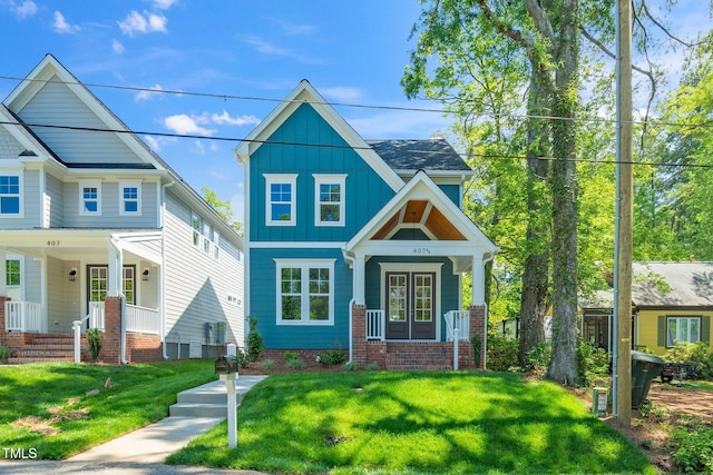 view of front of property featuring covered porch, board and batten siding, and a front lawn