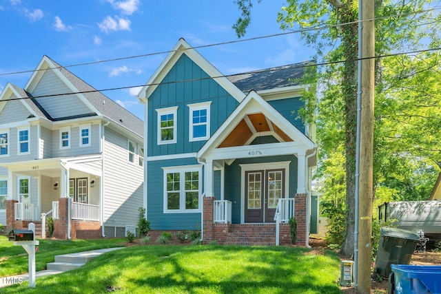 view of front of property with a porch, board and batten siding, and a front lawn