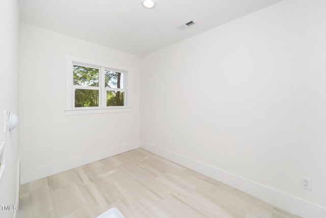 spare room with baseboards