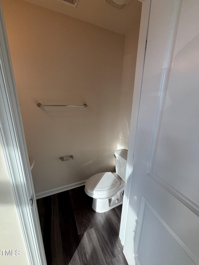 bathroom with wood finished floors and toilet