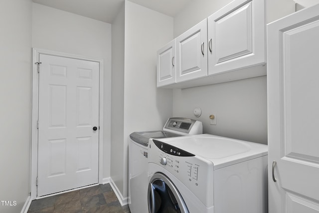 laundry room with independent washer and dryer, cabinet space, stone finish floors, and baseboards