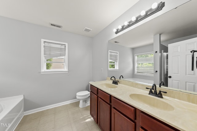 full bath featuring a bath, baseboards, toilet, and double vanity