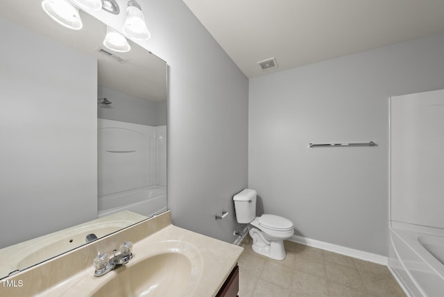 bathroom with vanity, toilet, baseboards, tile patterned floors, and bathtub / shower combination