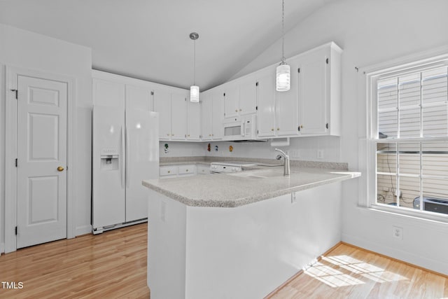 4705 Forest Highland Dr, Raleigh, NC 27604 - kitchen featuring white appliances, a sink, light wood-style flooring, lofted ceiling, and a peninsula