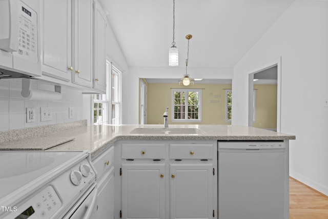 4705 Forest Highland Dr, Raleigh, NC 27604 - kitchen with white appliances, a sink, lofted ceiling, white cabinetry, and a peninsula