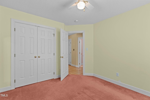 4705 Forest Highland Dr, Raleigh, NC 27604 - unfurnished bedroom featuring light carpet, baseboards, a closet, ceiling fan, and a textured ceiling