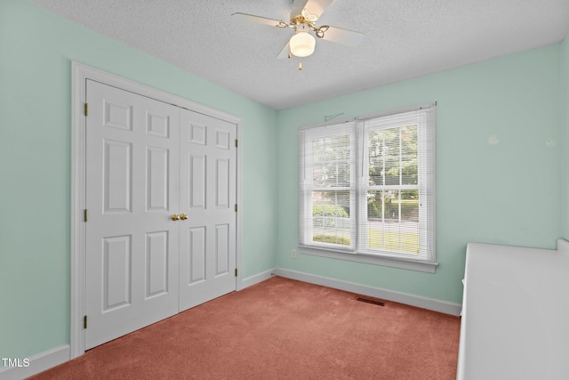 4705 Forest Highland Dr, Raleigh, NC 27604 - unfurnished bedroom with light carpet, a textured ceiling, baseboards, a closet, and a ceiling fan