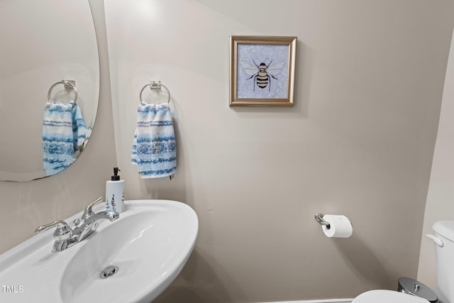 half bathroom with a sink and toilet