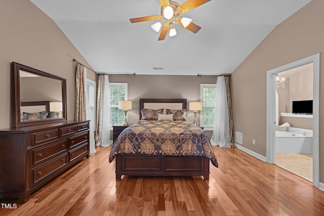 bedroom with lofted ceiling, light wood-style flooring, baseboards, ensuite bathroom, and ceiling fan