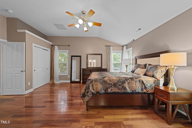 bedroom featuring wood finished floors, lofted ceiling, ceiling fan, and baseboards