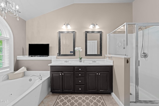 full bath featuring lofted ceiling, a bath, tile patterned floors, a shower stall, and double vanity