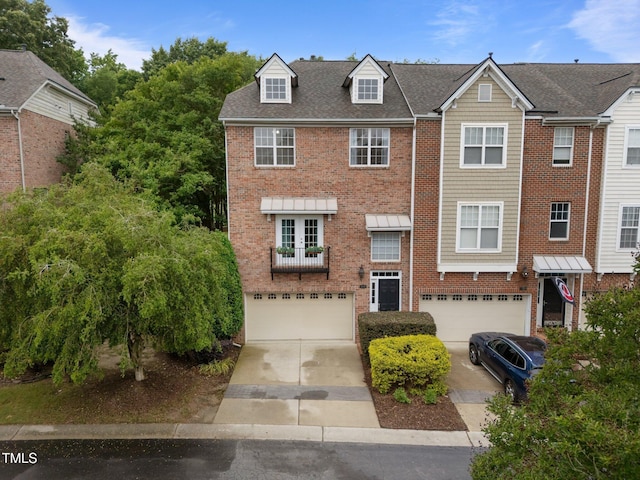 view of front of home with a garage, brick siding, and driveway
