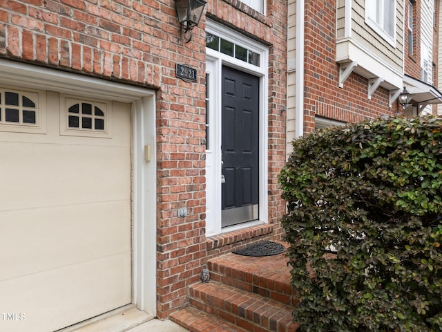 doorway to property with brick siding