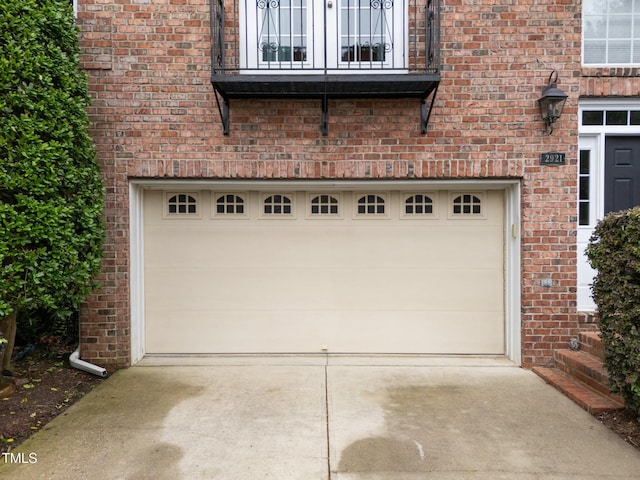 garage featuring concrete driveway