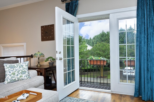 doorway to outside with crown molding and hardwood / wood-style floors
