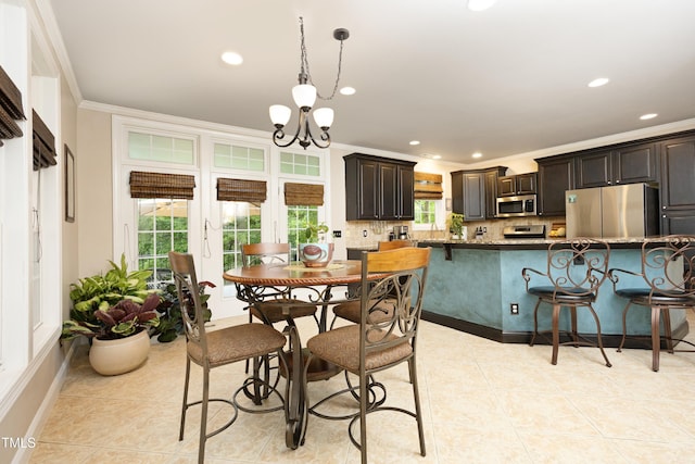 dining area with ornamental molding, recessed lighting, a chandelier, light tile patterned floors, and baseboards