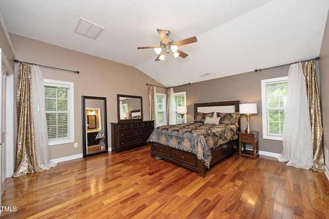 bedroom with light wood-style flooring, lofted ceiling, multiple windows, baseboards, and ceiling fan