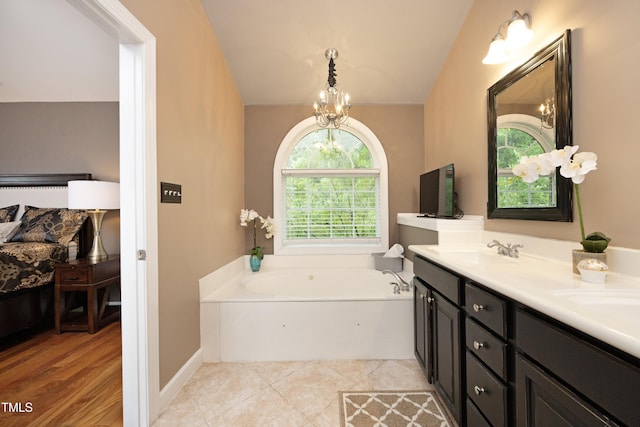full bath featuring a garden tub, a chandelier, double vanity, and tile patterned flooring