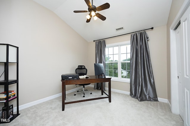 office area featuring lofted ceiling, light colored carpet, a ceiling fan, and baseboards