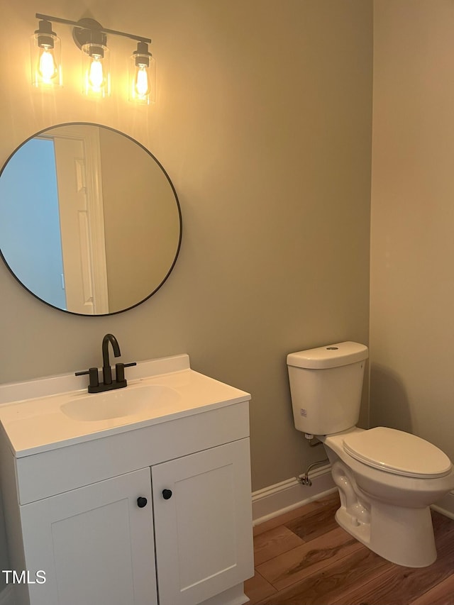 8100 Laurel Mountain Rd, Raleigh, NC 27613 - half bathroom featuring wood finished floors and vanity