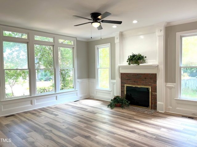 8100 Laurel Mountain Rd, Raleigh, NC 27613 - unfurnished living room with a decorative wall, ornamental molding, wood finished floors, ceiling fan, and a fireplace