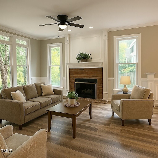 8100 Laurel Mountain Rd, Raleigh, NC 27613 - living area with a decorative wall, ornamental molding, light wood finished floors, a ceiling fan, and a wainscoted wall