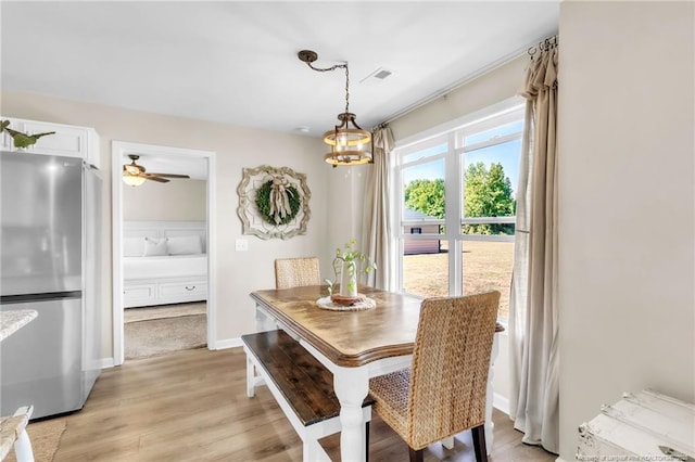 6955 S W St, Godwin, NC 28344 - dining space with light wood finished floors and a chandelier