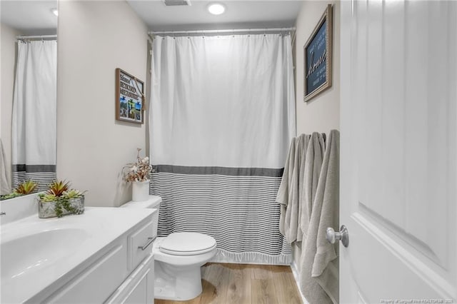 6955 S W St, Godwin, NC 28344 - full bath with wood finished floors, vanity, toilet, and a shower with curtain