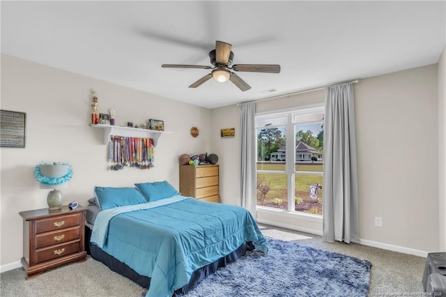 6955 S W St, Godwin, NC 28344 - bedroom with light carpet, baseboards, and a ceiling fan