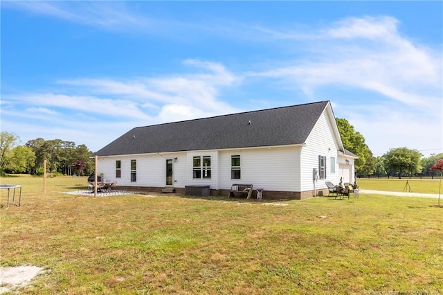 6955 S W St, Godwin, NC 28344 - rear view of house with a trampoline and a lawn