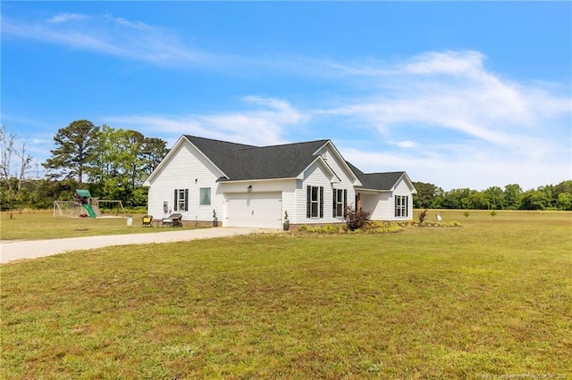 6955 S W St, Godwin, NC 28344 - view of front of home with concrete driveway, a garage, a front yard, and a playground