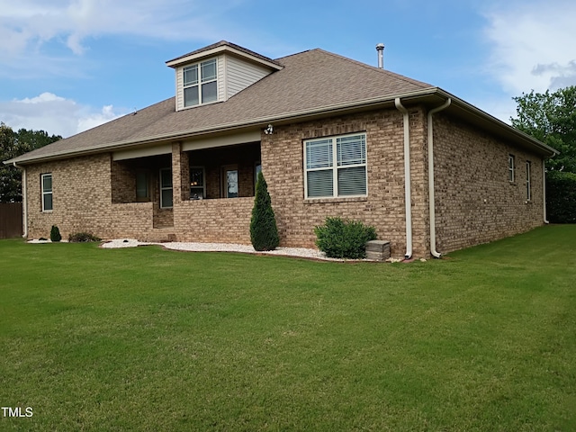 243 Nortwick Rd, Rolesville, NC 27571 - rear view of property featuring a lawn, brick siding, and a shingled roof