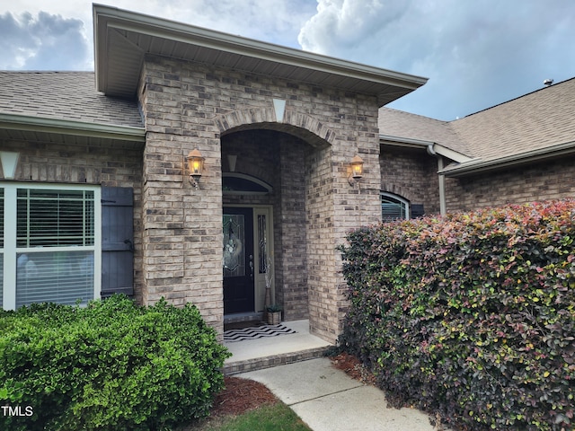 243 Nortwick Rd, Rolesville, NC 27571 - doorway to property with roof with shingles, stone siding, and brick siding