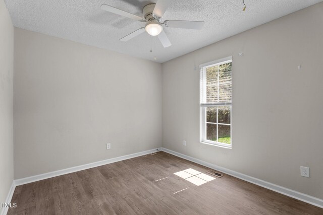 765 S Hollybrook Rd, Wendell, NC 27591 - spare room featuring wood finished floors, a textured ceiling, baseboards, and a ceiling fan