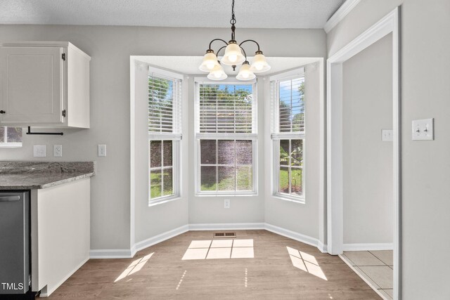 765 S Hollybrook Rd, Wendell, NC 27591 - unfurnished dining area featuring a chandelier, light wood-style flooring, and baseboards