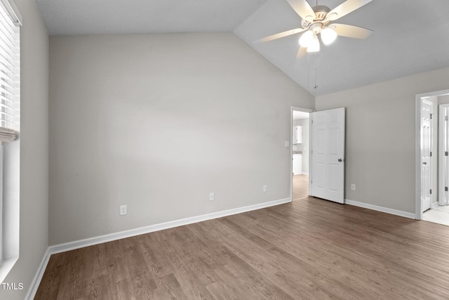 765 S Hollybrook Rd, Wendell, NC 27591 - unfurnished bedroom with wood finished floors, baseboards, high vaulted ceiling, ensuite bath, and ceiling fan