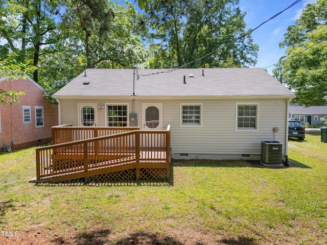 rear view of house featuring crawl space, central AC, a deck, and a yard