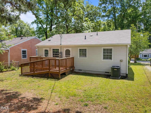 back of property with crawl space, a wooden deck, central AC unit, and a lawn