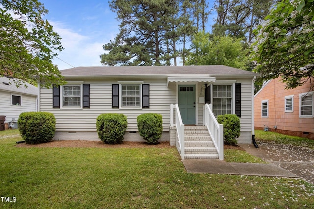 view of front facade with crawl space, a front yard, and a shingled roof