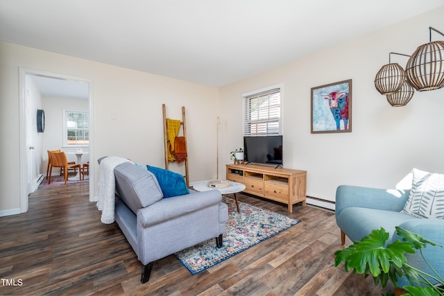 living area with healthy amount of natural light, a baseboard radiator, wood finished floors, and baseboards